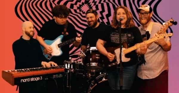 The five members of The Dirty Middle playing together: keys, lead guitar, drums, vocals and guitar, and bass